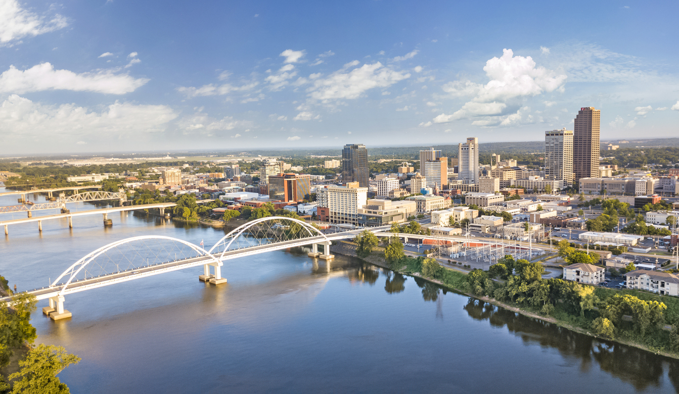 an aerial view of a city with a bridge over a river