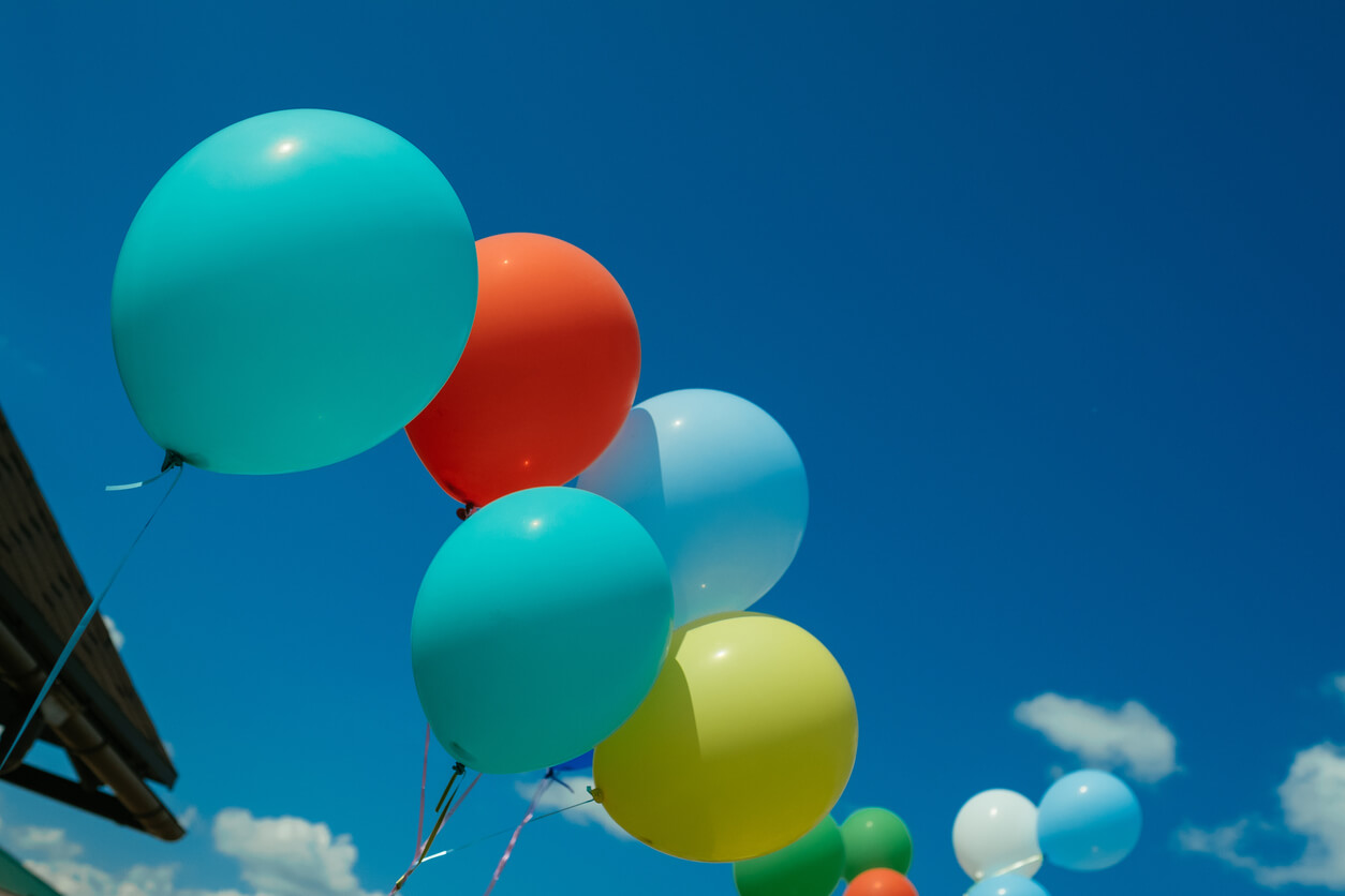 a bunch of colorful balloons against a blue sky